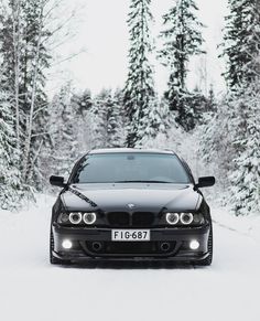 a black car is parked in the snow