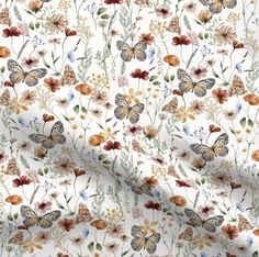 a white fabric with flowers and butterflies on it