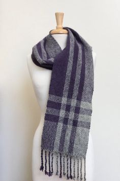 a gray and black plaid scarf on a mannequin