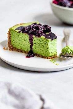 a piece of cheesecake on a plate with blueberries