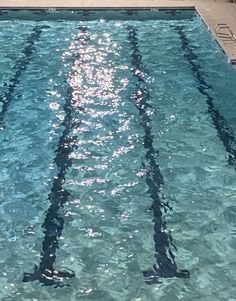 an empty swimming pool with sun reflecting off the water