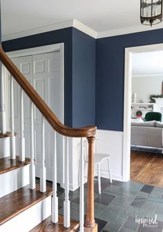 the stairs in this house are painted blue with white trim and wood handrails