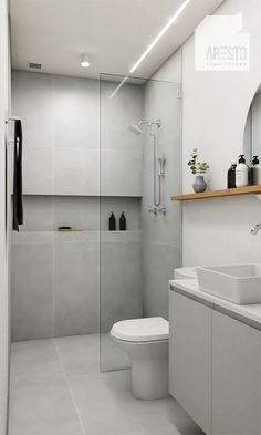 a white bathroom with a sink, toilet and shower stall in it's corner