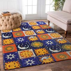 an area rug with sun, moon and stars on it in front of a couch