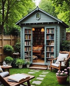 a small garden shed with bookshelves, chairs and tables in the back yard