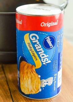 a can of croissants sitting on top of a wooden table