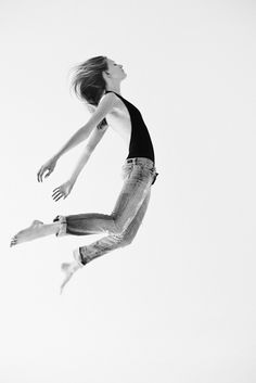 a woman is jumping in the air on her skateboard with an inspirational quote above her