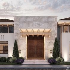 the front entrance to a modern home at dusk