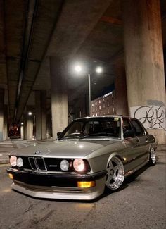 a car parked under an overpass at night