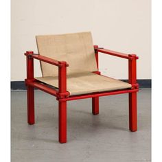 a red chair sitting on top of a cement floor