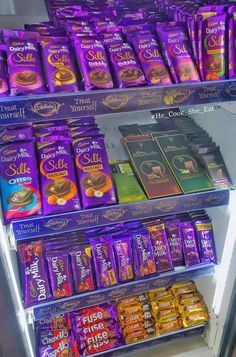 a display case filled with lots of different types of chocolates and candy bar wrappers