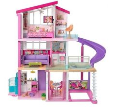 a pink doll house with furniture and accessories