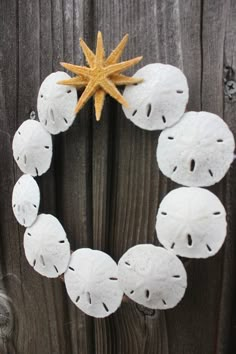 a wreath made out of sand dollars with a starfish on top