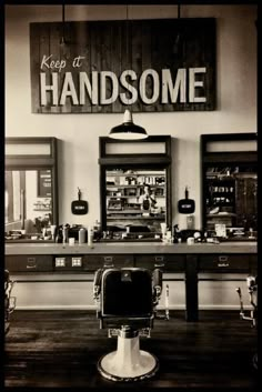 the inside of a barbershop with two chairs and one chair in front of it