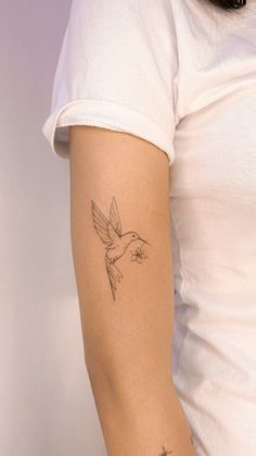 a woman with a small tattoo on her arm