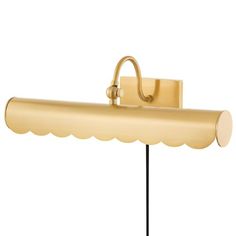 a brass colored wall light with a scalloped shade on the side and a black base