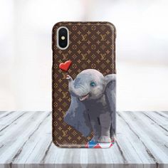 an elephant with a red heart on it's trunk is standing in front of a louis vuitton phone case