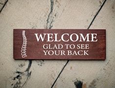 a wooden sign that says welcome glad to see your back