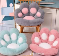 three chairs with paw prints on them sitting in front of a mirror and chair next to each other