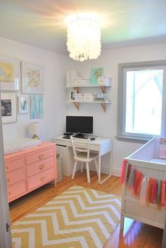 a baby's room with pink furniture and pictures on the wall