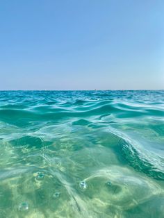 the water is very clear and blue with little bubbles on it's surface in the ocean