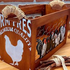 a wooden box filled with chickens on top of a table