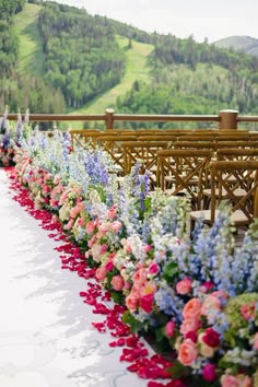 rows of chairs with flowers lining the aisle