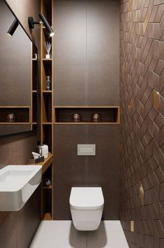 an instagram photo of a bathroom with brown and white tiles on the walls, along with a toilet and sink