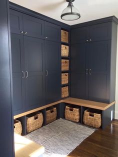 a room with blue cabinets and baskets on the floor