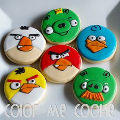 four angry birds decorated cookies sitting on top of a white plate with the words color me cookie