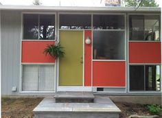 the front door of a house with orange, yellow and red panels