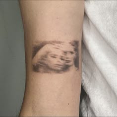 a person's arm with a tattoo on it that has an image of a hand