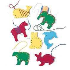 an assortment of felt animal ornaments on a white background