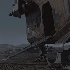 a large metal object sitting on top of a dirt field