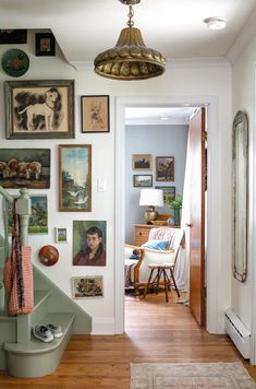 a hallway with pictures on the wall and stairs