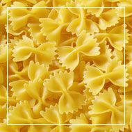 close up view of yellow pasta textured with small pieces of plastic food wrapper