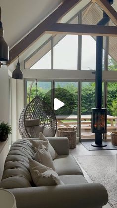 a living room filled with furniture and a fire place in front of a large window