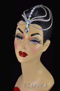 a mannequin head wearing a tiara with jewels on it's head