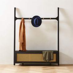 a coat rack with hat and scarf on it