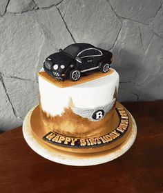 a birthday cake with two cars on top