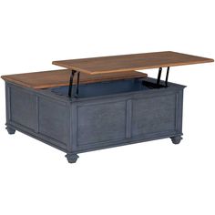 a large wooden table sitting on top of a blue trunk under a white background with an open drawer underneath it