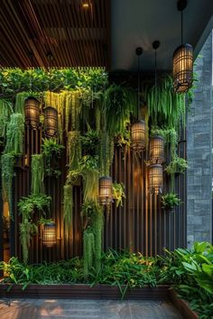 an indoor plant wall with hanging plants and lights in the center, surrounded by greenery