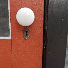 the door is painted orange and has a white knob on it's front door