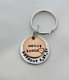 a penny keychain with the words mommy since and another penny on it's side