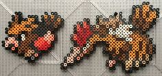 some type of art made out of plastic beads on a white surface with black and orange circles