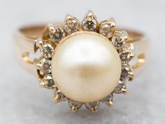 Champagne all around! These gorgeous stones perfectly compliment each other. The warm-hued champagne pearls are accented by a halo of champagne diamonds. This ring is ready to be dressed up or down!Metal: 14K Yellow GoldGem: PearlGem Measurements: 7.8 mm, RoundAccents: 15 Diamonds totaling .30 Carats, I1 in Clarity, Champagne in ColorRing Size: 6.25Marks: "14K" Stamped on the inside band Pearl Rings Vintage, Gemstone Rings Vintage, Gold Pearl Ring, Diamond Halo Ring, Rose Gold Band, June Birthstone, White Gold Band, Champagne Diamond, Halo Diamond Ring