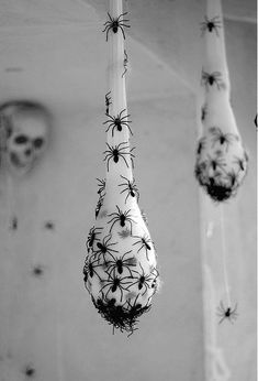 two spider webs hanging from the side of a bathtub in black and white