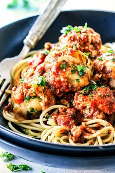 a bowl filled with spaghetti and meatballs