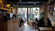 people are sitting at tables in a restaurant