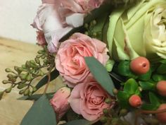 a bouquet of flowers sitting on top of a wooden table